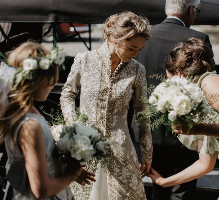 Bride Prepares To Enter Church With Bridal Party In Bridal Coat