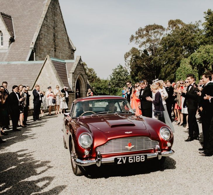 Bride and Groom Drive Off In Vintage Car