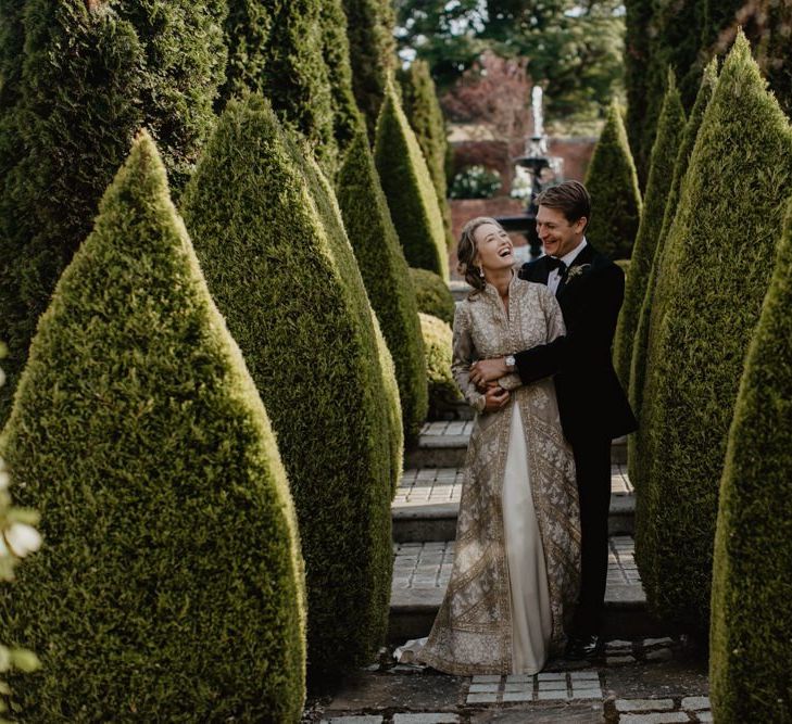 Bride And Groom Embrace In House Gardens