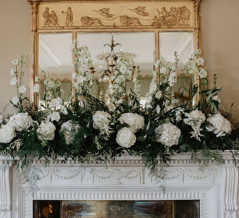 White Flower Decor On Mantlepiece