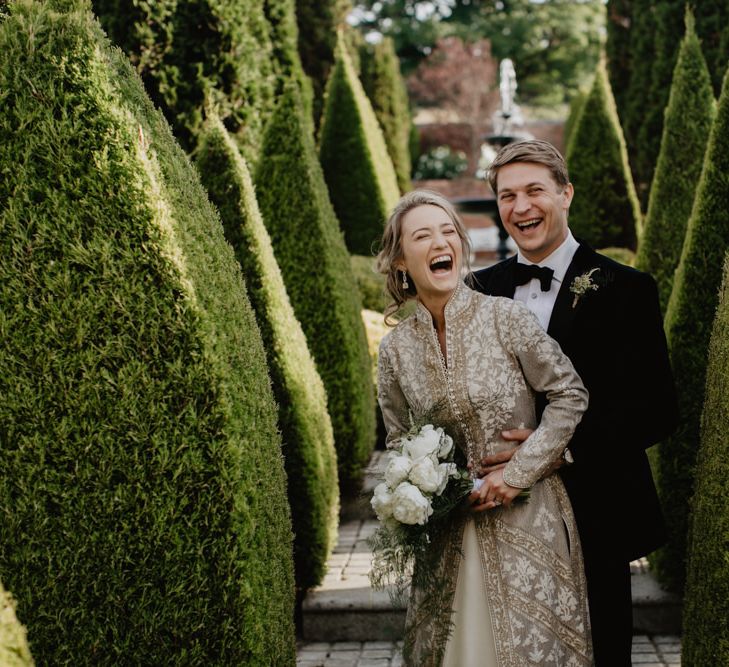 Bride and Groom Embrace in Gardens