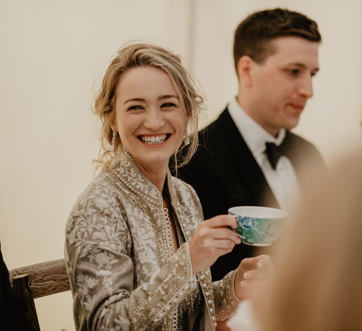 Bride Laughs During Speeches and Drinks From Tea Cup