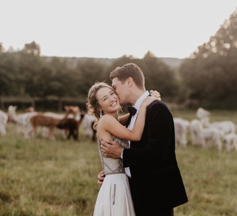 Bride in Halterneck Top and Satin Skirt Bridal Separates and Groom in Tuxedo Embracing