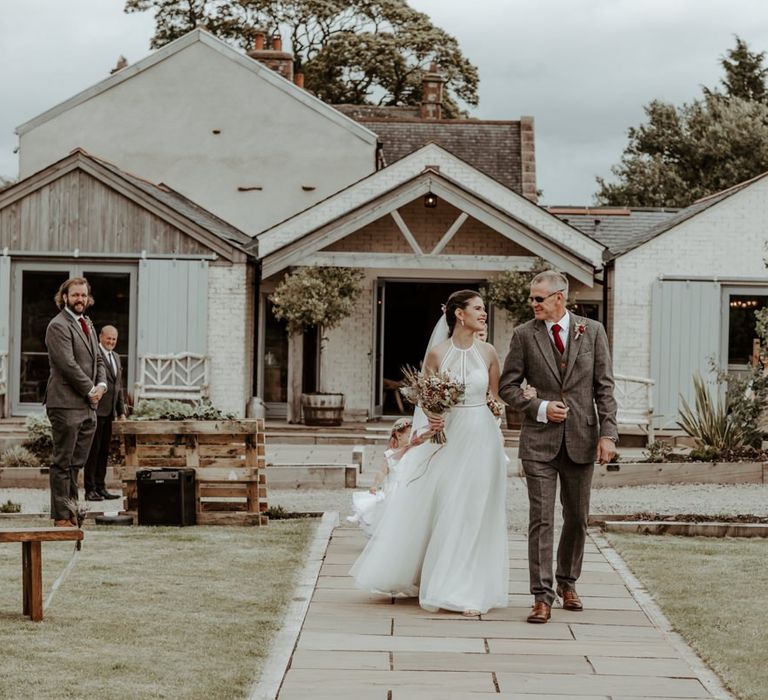 Bridal entrance at outdoor wedding ceremony at Eden Barn