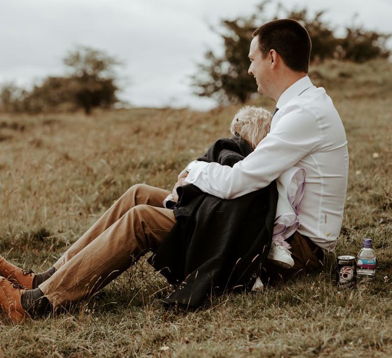 Wedding guests cradling a child at Eden Barn wedding