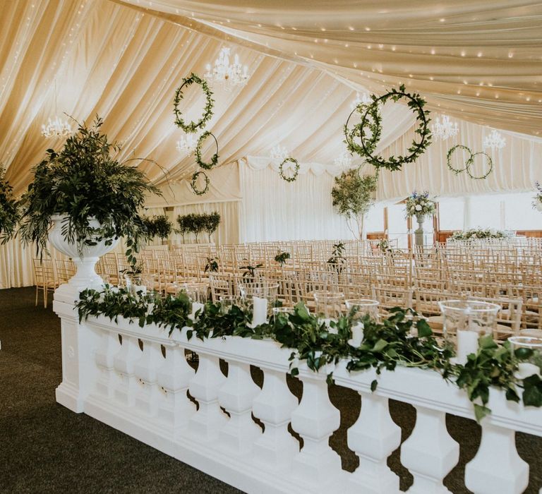 Hoop wedding decor at marquee ceremony with wooden wedding signs