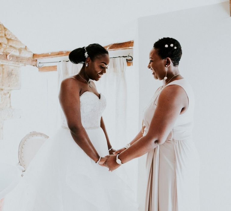 Bride has a moment with mother in strapless wedding dress