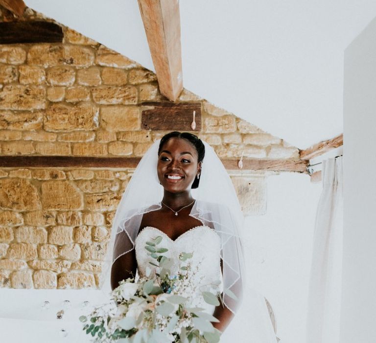 Bride with large bouquet and strapless wedding dress