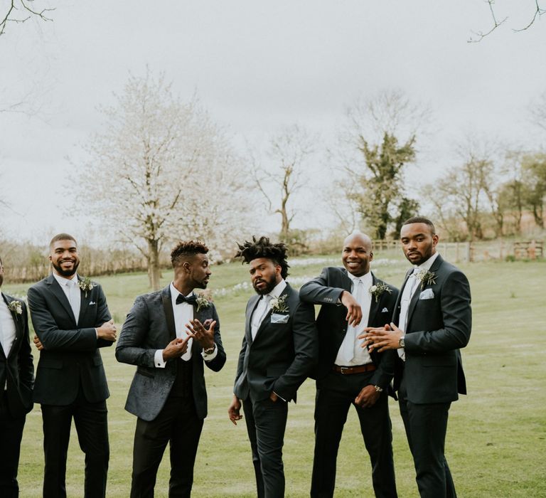 Groomsmen in blue ties with groom in blue dinner jacket