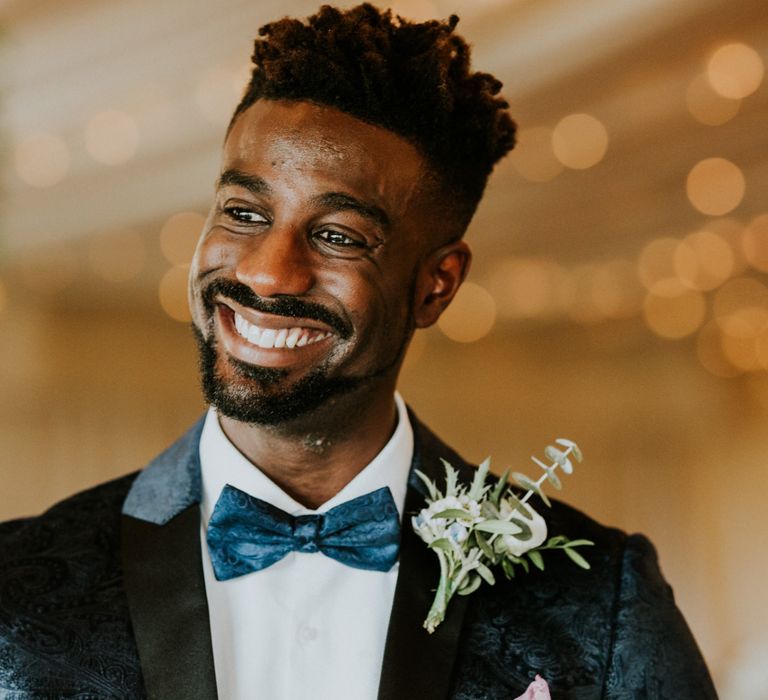 Groom in blue bowtie and dinner jacket