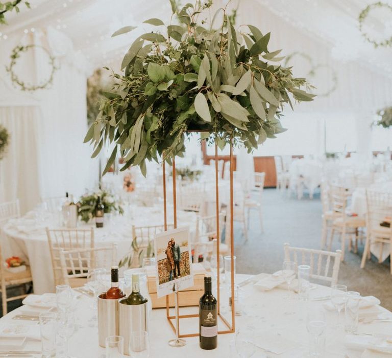 Foliage wedding decor with wooden wedding signs and hoop decoration