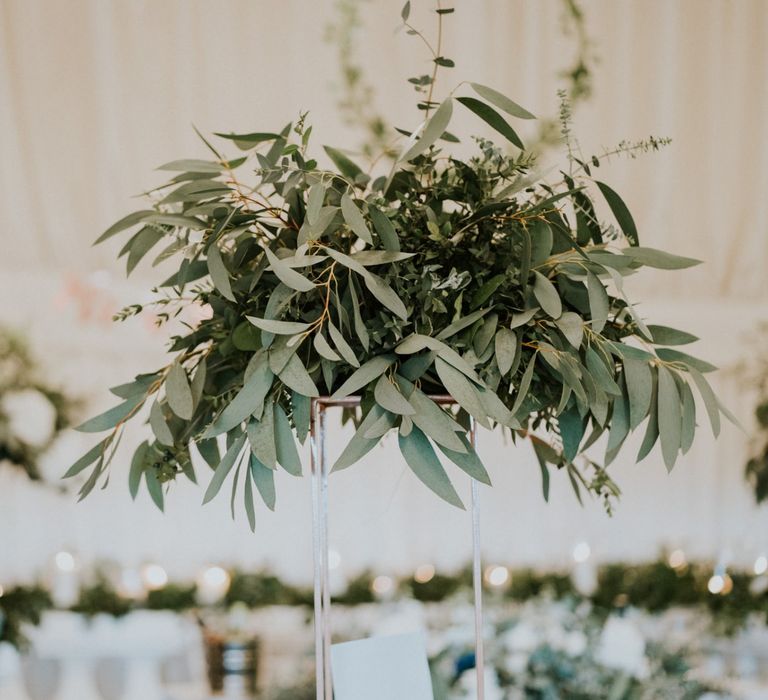 Foliage wedding decor with wooden wedding signs and hoop decoration