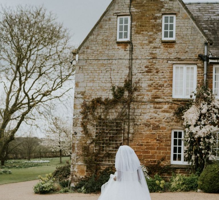 Bride wearing strapless wedding dress with veil at Crockwell Farm