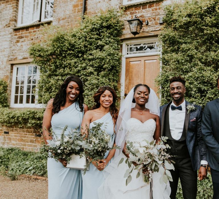 Bride and groom with bridesmaids in blue dresses