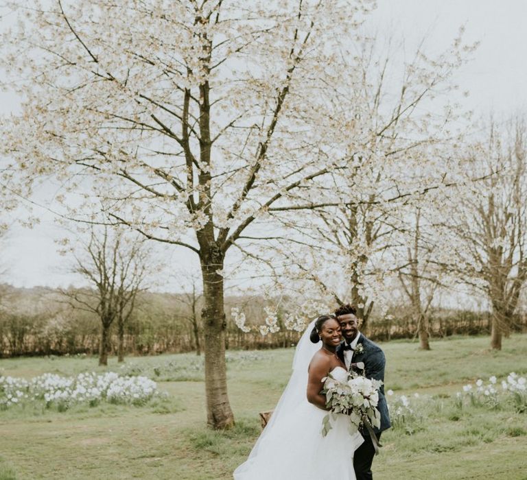 Bride wearing strapless wedding dress with veil at Crockwell Farm