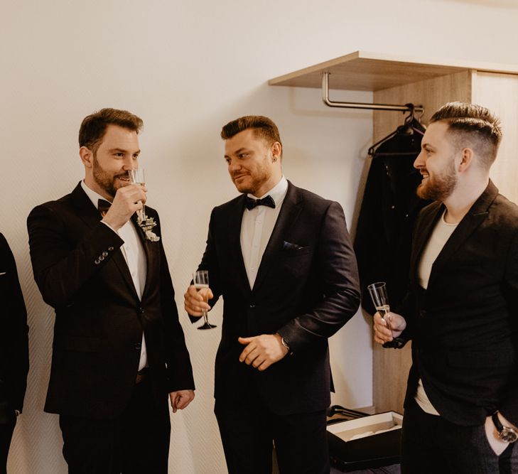 Groom in brown wedding suit with groomsmen