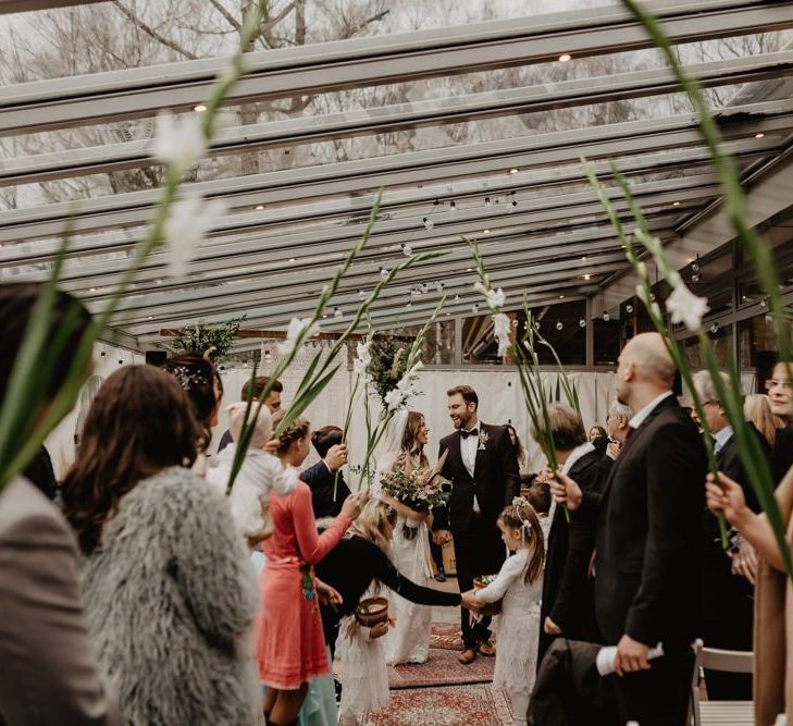 Bride and groom walk up the aisle after getting married