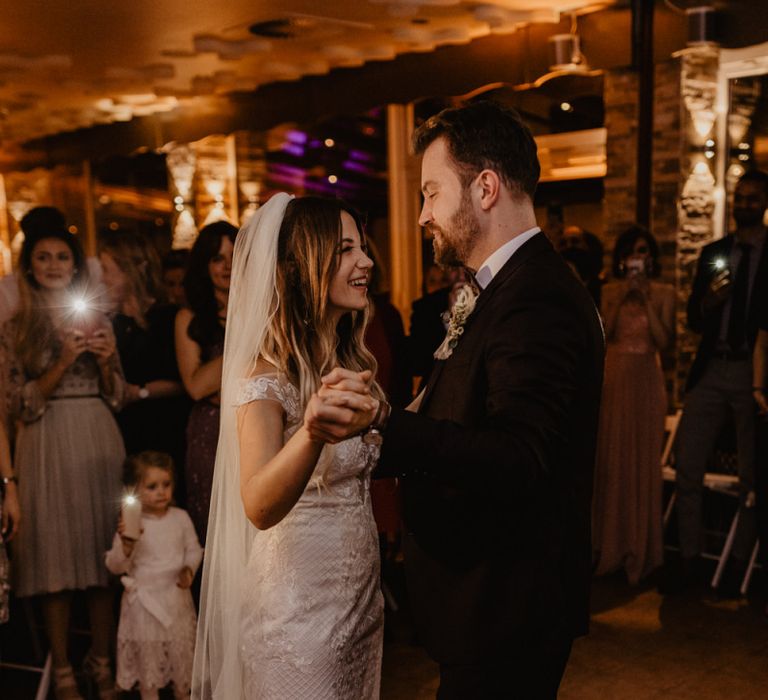 Bride and groom in brown wedding suit first dance