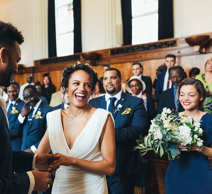 Bride and Groom exchanging vows with groom in check blazer