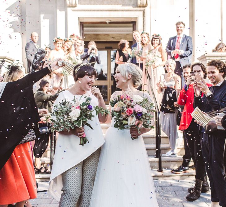 Lesbian wedding with bride in dress and trouser suit