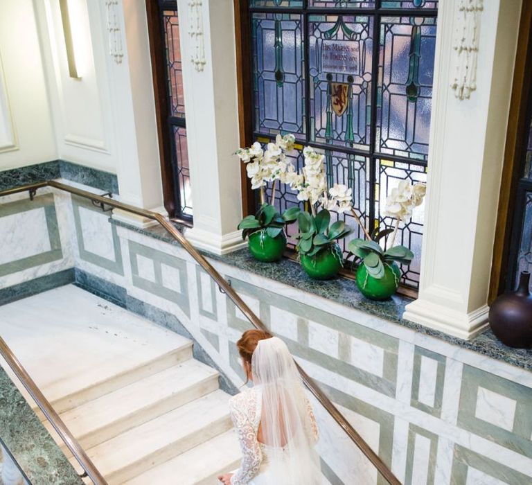 Bride walking up the step with long sleeve wedding dress