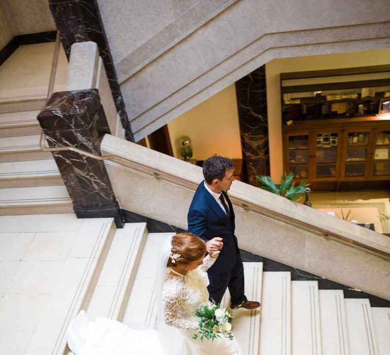 Bride and groom walking down the stairs