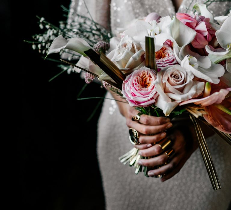 contemporary bridal with gold sprayed palms, roses, orchids and anthuriums