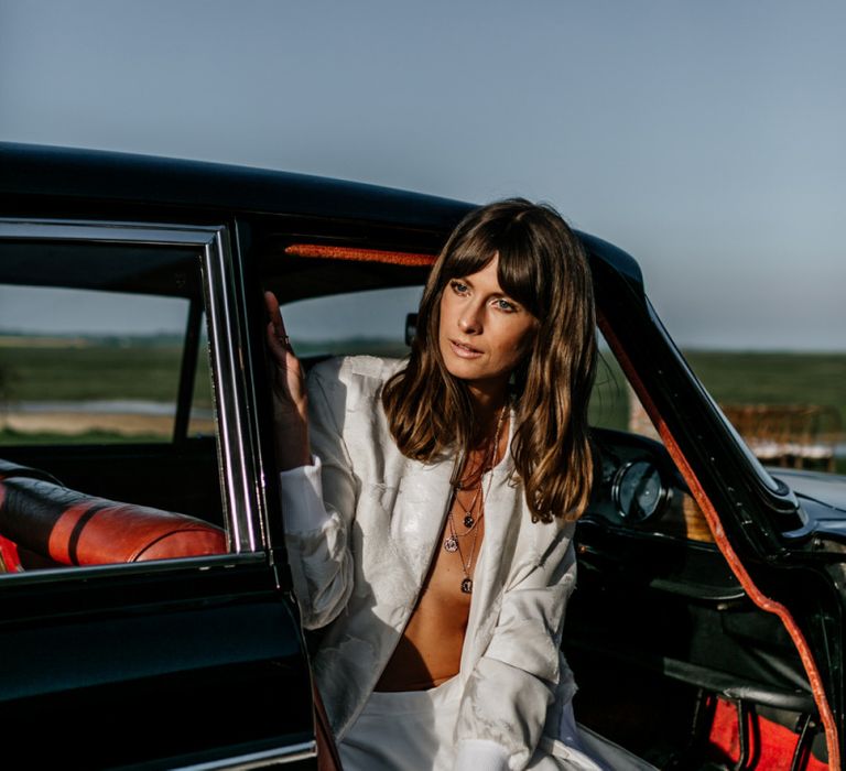 Boho Bride with Sweeping Fringe Sitting in a Wedding Car