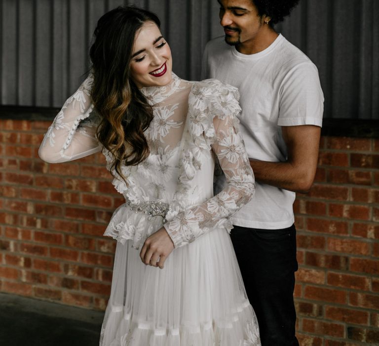 Bride Putting on a Edwardian Style High Neck Wedding Dress