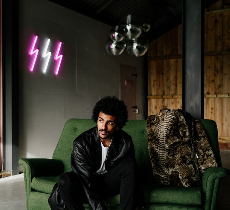 Stylish Groom in Leather Jacket Sitting on a Retro Sofa