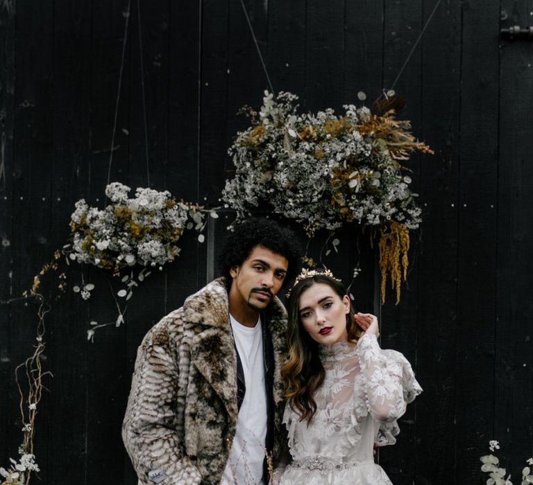 Stylish Bride and Groom in Lace Wedding Dress and Faux Fur Overcoat