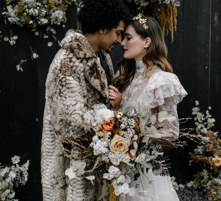 Intimate Portrait of Bride and Groom Standing Next to Their Dried Flower Arrangement