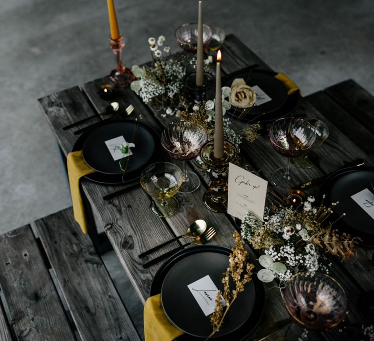 Winter Wedding Decor with Black Plates, Yellow Napkins and Taper Candles