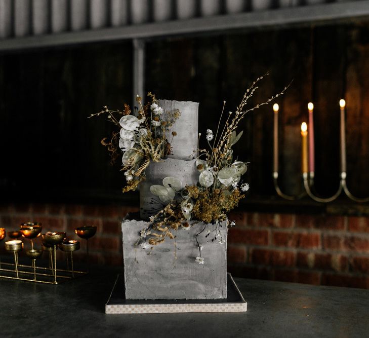 Stylish Concrete Wedding Cake with Gold Candelabras