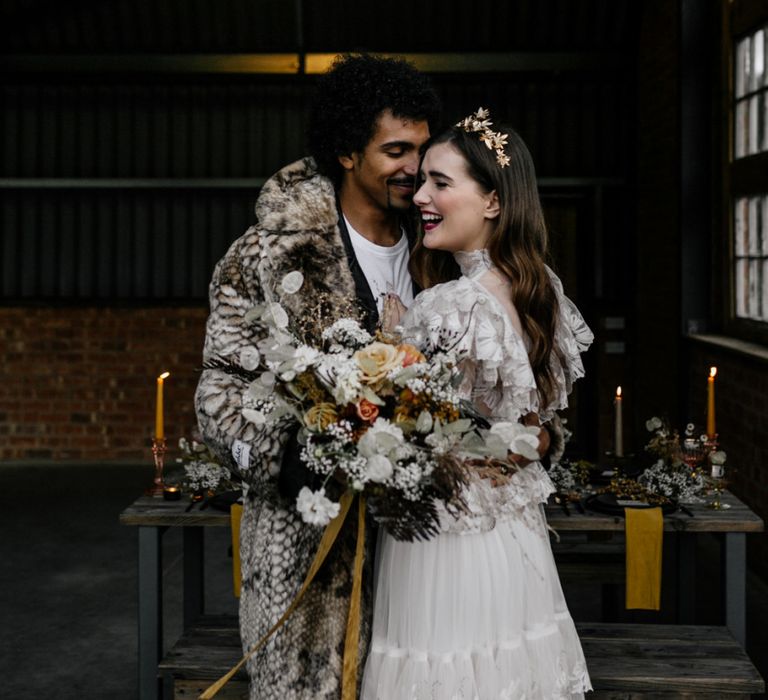 Stylish Bride and Groom Embracing Next to the Tablescape