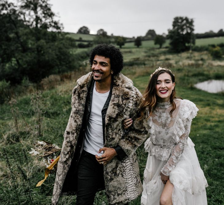 Happy Bride and Groom Arm in Arm in the Countryside