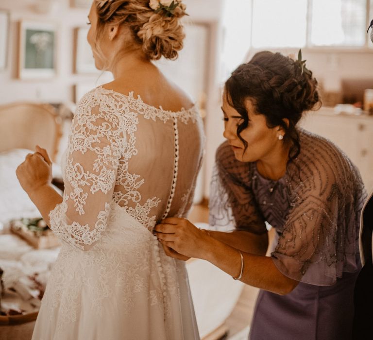 Bride in illusion and lace back wedding dress with button back