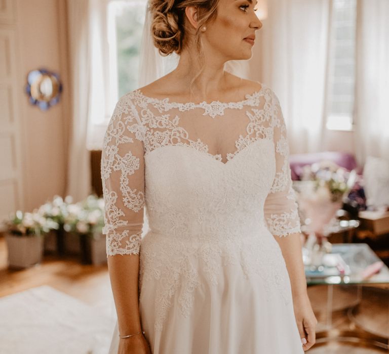 Bride in lace slash neck wedding dress with 3/4 sleeves