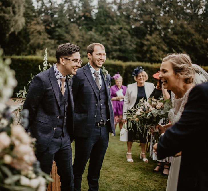 Bride and grooms happy reaction to each other at the end of the aisle