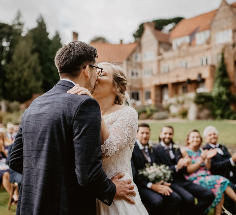 You may now kiss the bride moment at outdoor wedding ceremony at Voewood