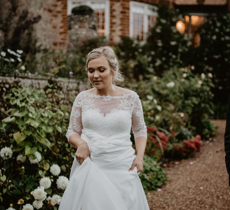 Beautiful bride in lace Bardot wedding dress with 3/4 sleeves