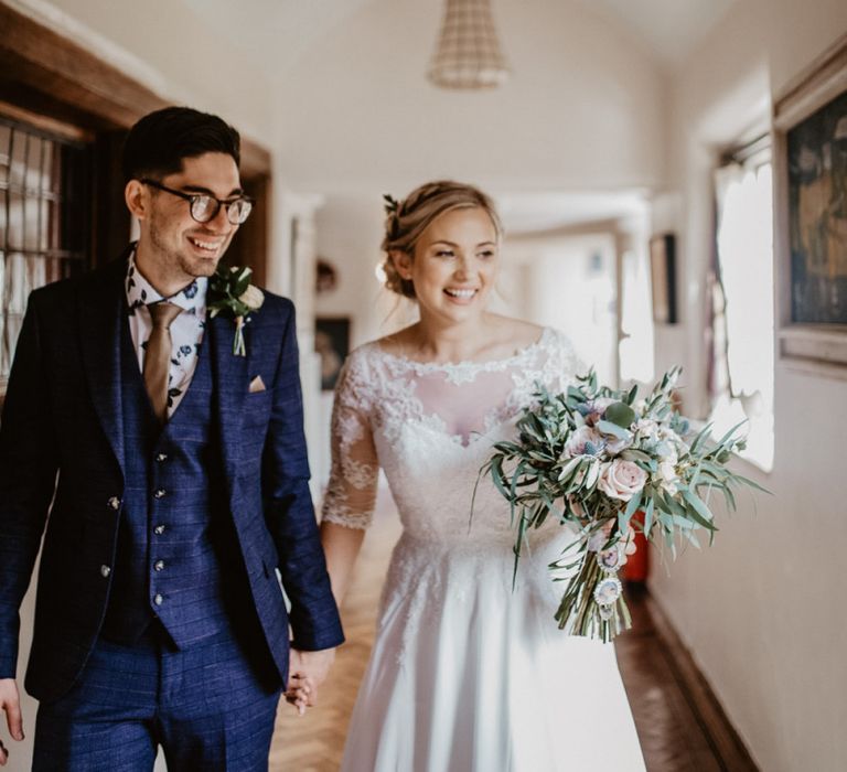 Bride in lace Bardot wedding dress and groom in navy suit at Voewood wedding