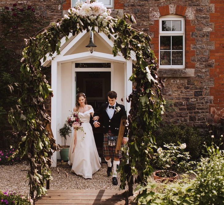 Brother in Tartan Kilt Escorting the Bride in a Bardot Art Couture Satin Wedding Dress to the Wedding Ceremony