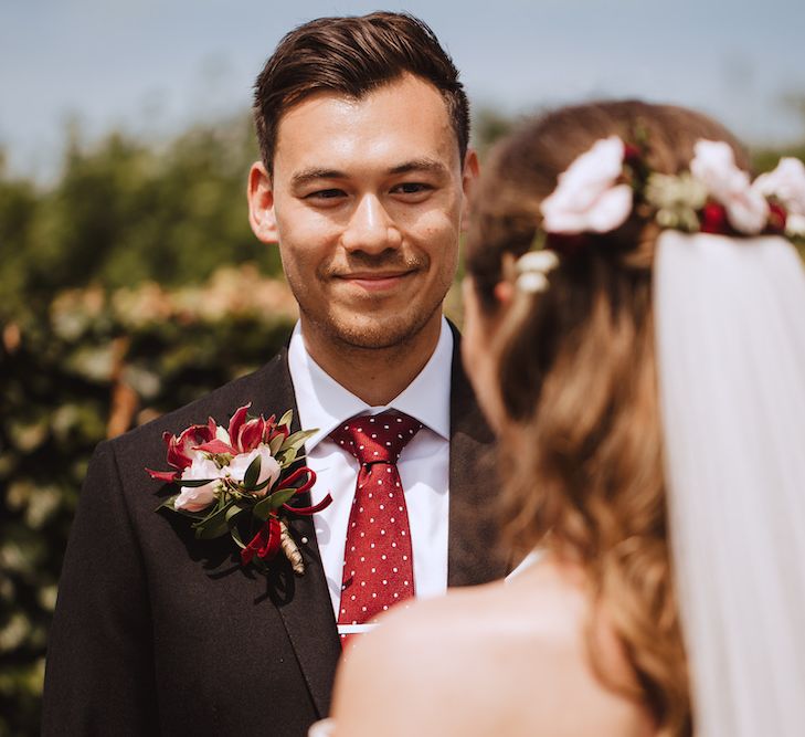 Groom in Black Suit, White Shirt and Burgundy Polka Dot Tie