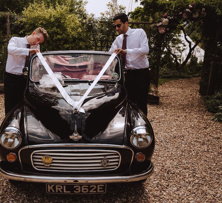 Groomsmen Tying Ribbon on a Vintage Wedding Car