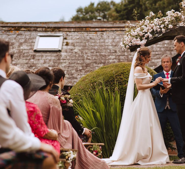 Bride and Groom Exchanging Vows at Their Outdoor Wedding Ceremony