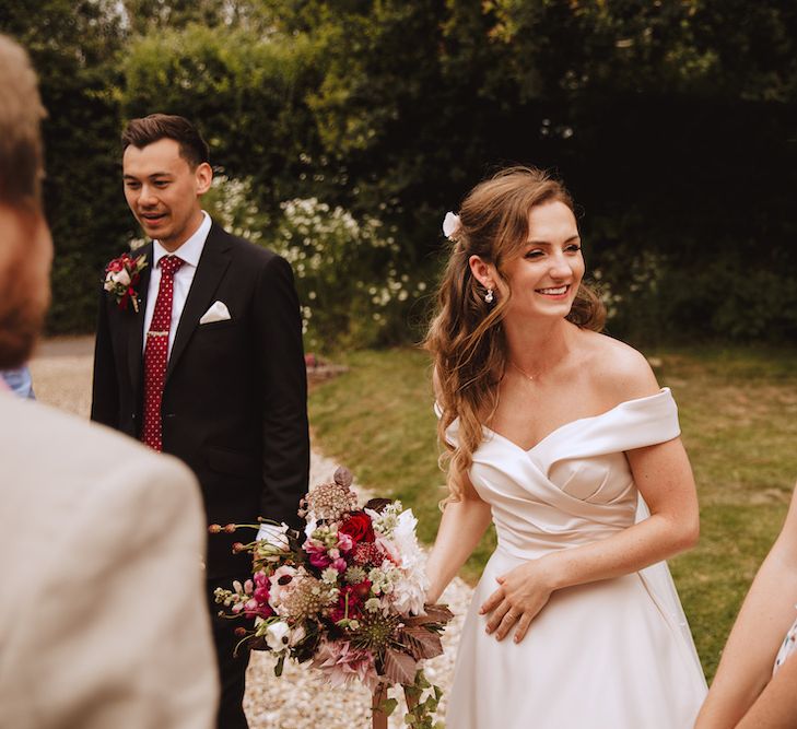 Beautiful Bride with Half Up Half Down Hair Greeting Wedding Guests