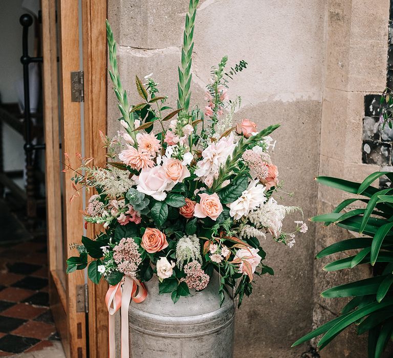 Milk Churn Wedding Floral Arrangement | Peach Wedding at Swanton Morley House and Gardens in Norfolk |  Jason Mark Harris Photography | Together we Roam Films