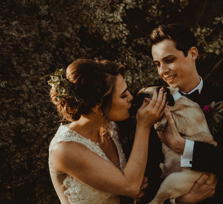 Bride in The Eleni Wed2B Lace Wedding Dress and Groom in Tuxedo with Their Pet Pug