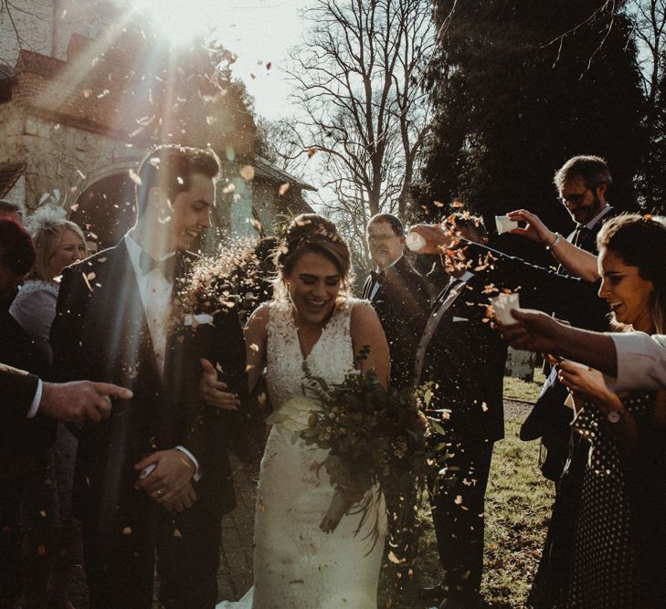 Sun Dappled Confetti Moment with Bride in The Eleni Wed2B Lace Wedding Dress and Groom in Tuxedo